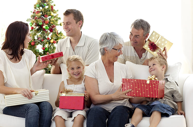 Weihnachtsgeschenke - Familie bei der Bescherung